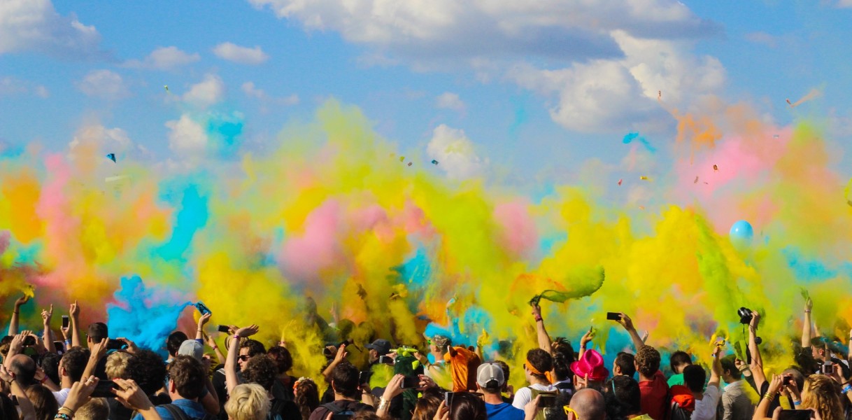 Image of Crowd with coloured power paint clouds 