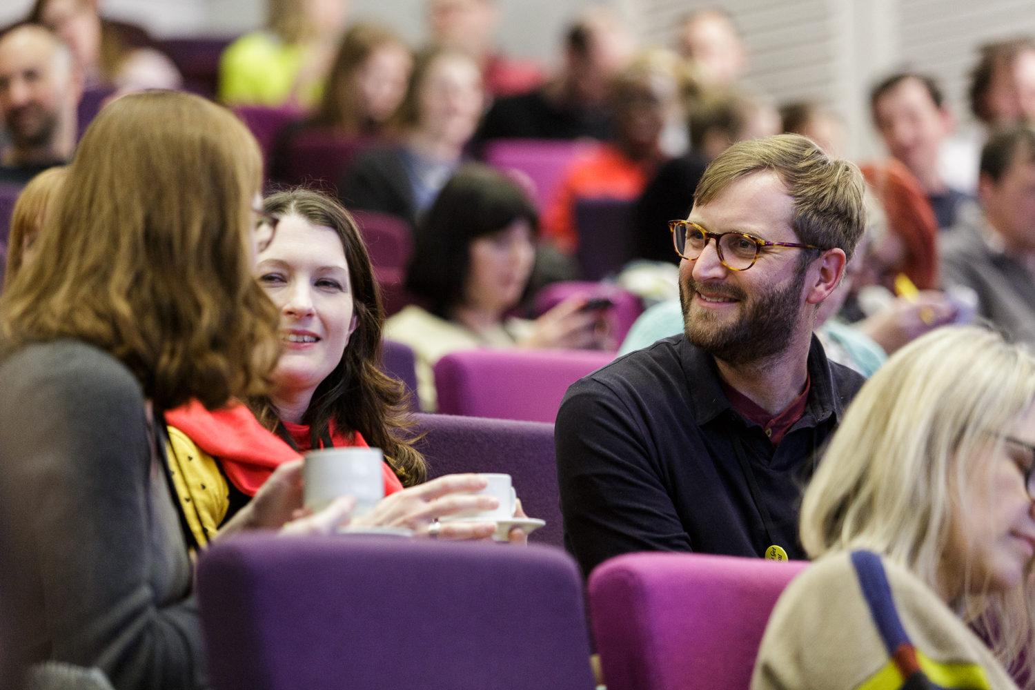 Previous attendees at a LGR conference chatting over a cup of tea