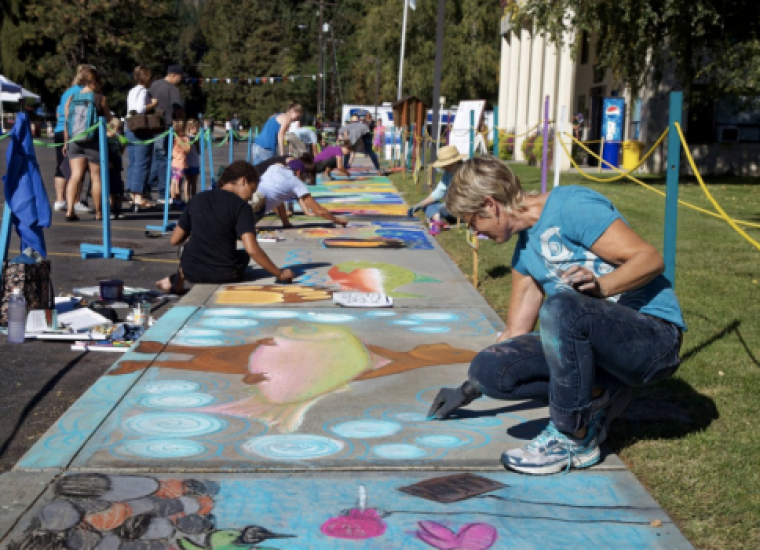 Image of artists painting on a pavement (Street art)