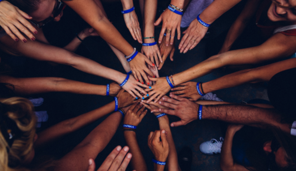 Image if group of volunteers joining hands in the middle