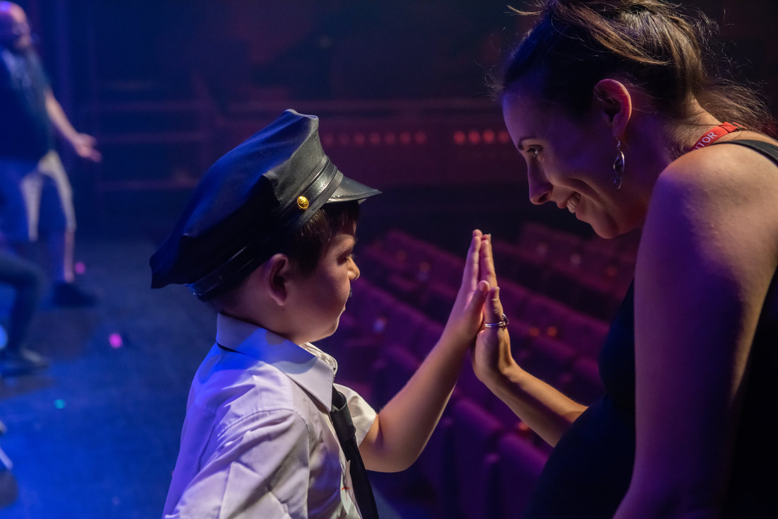 A woman and a boy on stage