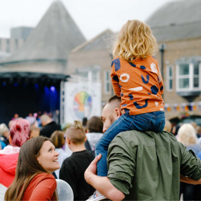 Child on parent's shoulders at an event in Tees Valley