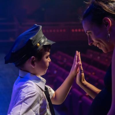 A woman and a boy on stage