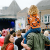 Child on parent's shoulders at an event in Tees Valley