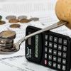 Image showing balancing potato and money on a calculator, illustrating cost of living crisis