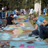 Image of artists painting on a pavement (Street art)