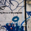 Graffiti on a wall saying "The Drone of Everyday Life" 