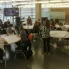 Conference delegates sitting around round tables and discussing