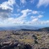 The peak of Scaffell Pike, a rocky landscape with blue skies and white clouds